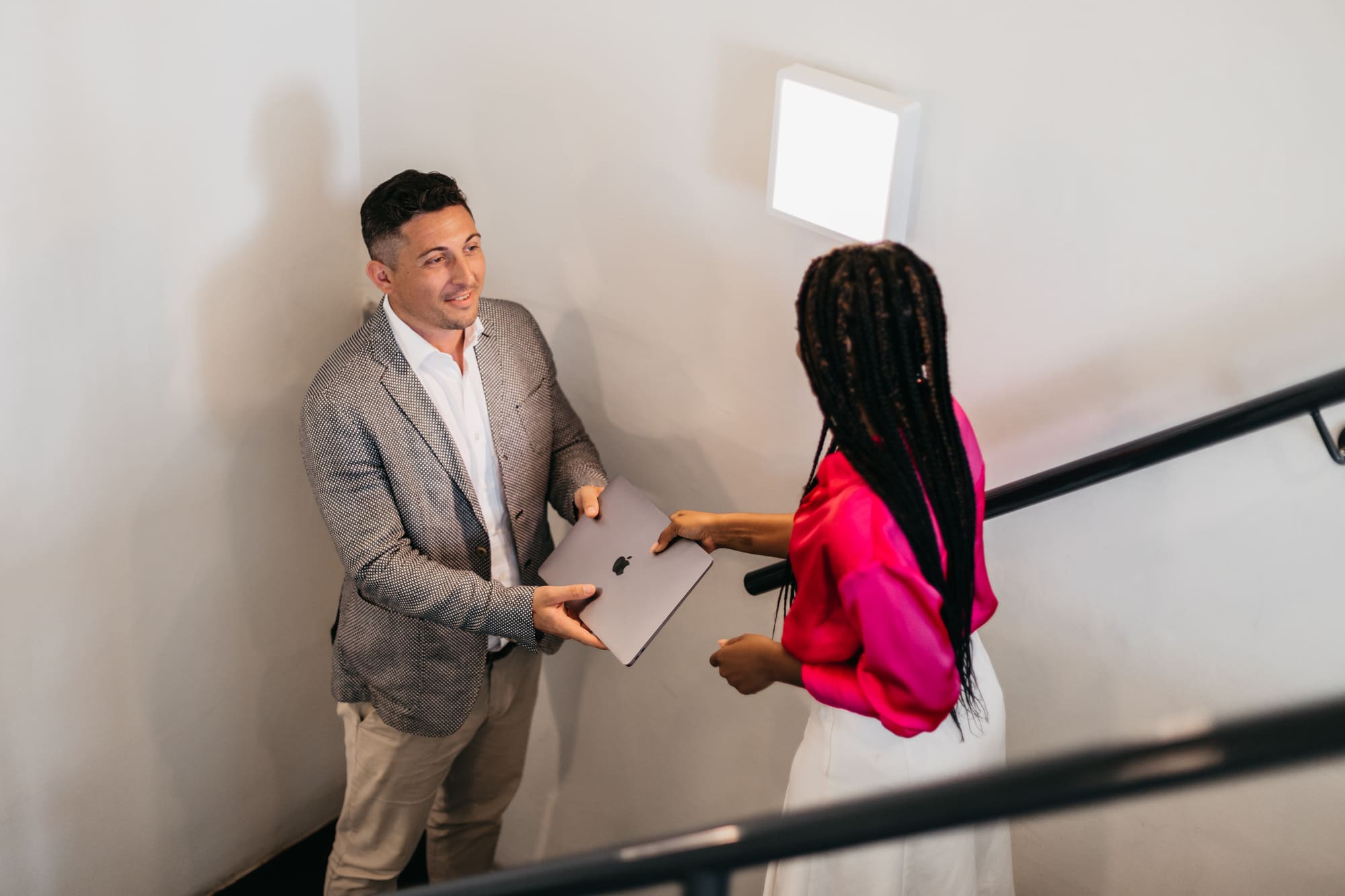 A man and a woman talking about local regulations and regulatory compliance